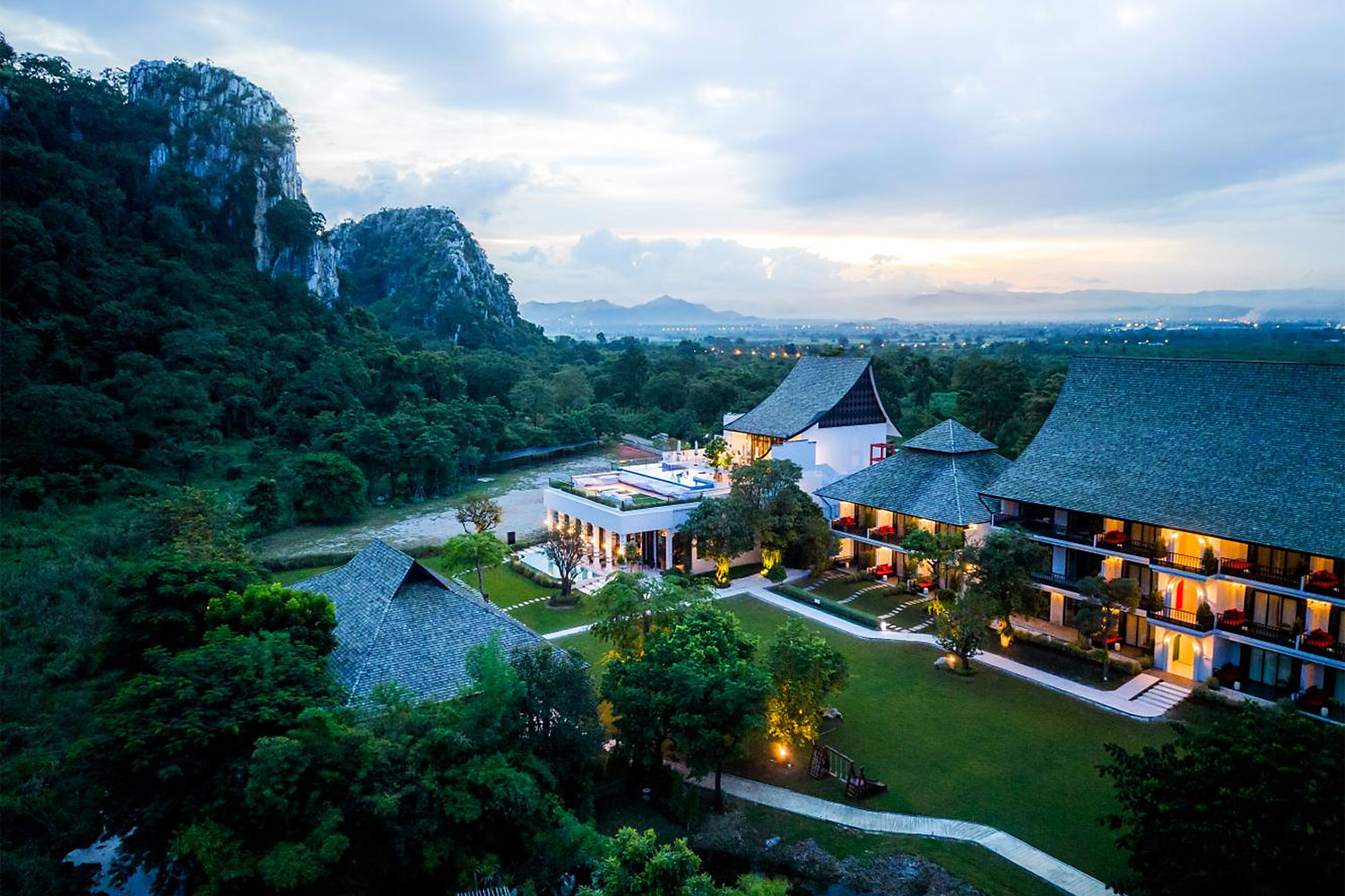 Cinematic view of a luxury wellness resort surrounded by Thai nature